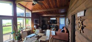 a person is sitting at a table in a house at Captain JaC's Hideaway in Mallorytown