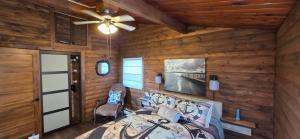 a dining room with a table and a ceiling fan at Captain JaC's Hideaway in Mallorytown