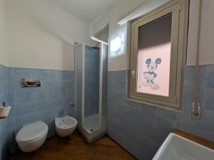a bathroom with a toilet and a shower and a sink at il grippiale in Aci Castello