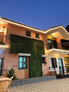 a large green door on the side of a house at Cinnamon Villa - The Dream Stays ll Pvt Pool ll 3Ac Rooms ll Wi-Fi in Khandāla