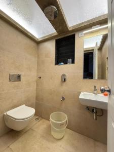 a bathroom with a toilet and a sink at Cinnamon Villa - The Dream Stays ll Pvt Pool ll 3Ac Rooms ll Wi-Fi in Khandāla +12 photos