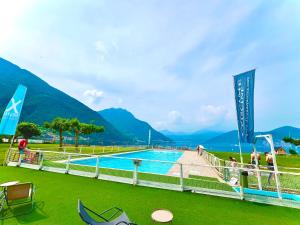 a swimming pool with mountains in the background at L4K3 Luxury Apartment - Lake View, Free Pool, Balcony, 50 m to Lake & Historic Center, 90 m2 in Pisogne