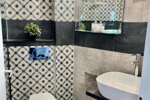 a bathroom with a white sink and a toilet at Stunning View Seaside 1-Bed Apartment in Saronida in Saronida