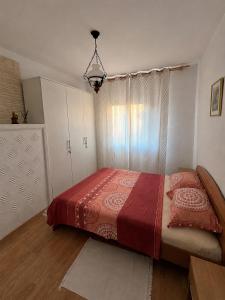 a bedroom with a large bed with a red blanket at Casa de Vacanta Sarinasuf in Sarinasuf +18 photos