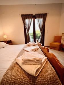 a bedroom with a bed with towels on it at Nancy in Politika