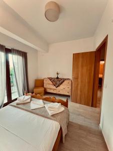 a bedroom with two beds and a wooden door at Nancy in Politika