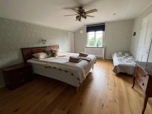a bedroom with a bed and a ceiling fan at Per Larsgård in Veddige