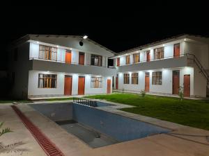 a large white building at night with its lights on at Las Lomas Hotel in Caraz
