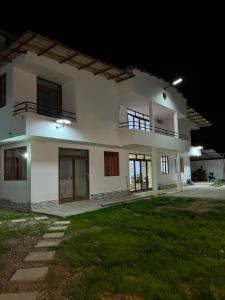 a large white house at night at Las Lomas Hotel in Caraz