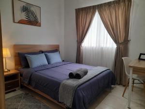 a bedroom with a bed with blue sheets and a window at Tiệm Ăn Villa 3 in Phước Lộc Xã