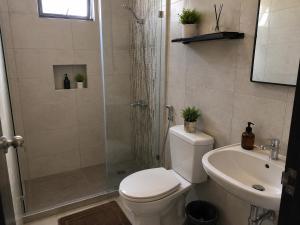 a bathroom with a shower and a toilet and a sink at Tiệm Ăn Villa 3 in Phước Lộc Xã