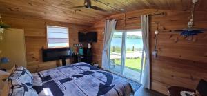 a bedroom with a bed and a view of the ocean at Captain JaC's Hideaway in Mallorytown