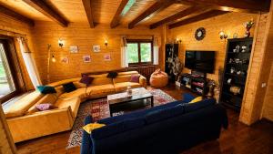 a living room with a couch and a television at Old Mark's House Sinaia in Sinaia