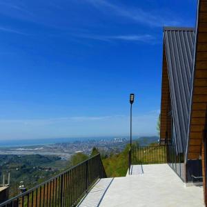 a balcony with a view of a city at Casa Verde&Mare in Sharabidzeebi
