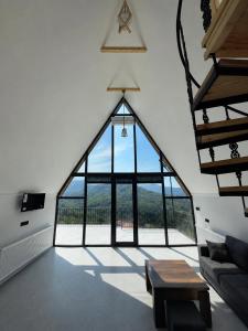 a room with a large glass window in a building at Casa Verde&Mare in Sharabidzeebi +1 photo