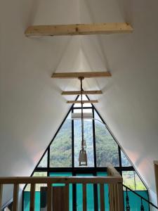 a room with a large window and a chandelier at Casa Verde&Mare in Sharabidzeebi