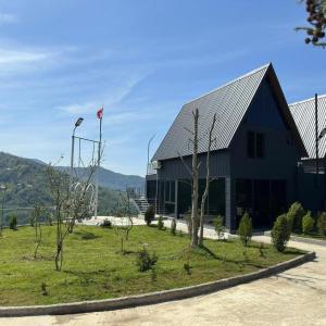 a large building with a flag in front of it at Casa Verde&Mare in Sharabidzeebi