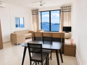 a living room with a table and chairs and a couch at Studio cosy vue sur mer in Mtsamboro