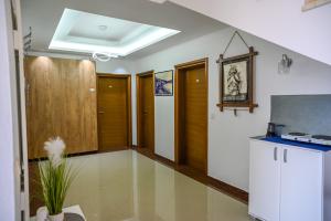 a living room with wooden doors and a table at Apartman Amin&Amina in Ulcinj