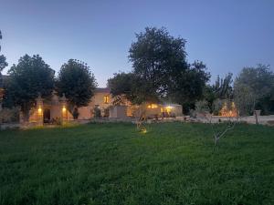 a house in a yard with a grass field at Domaine de la batelle in Arles