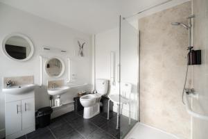 a bathroom with a toilet and a sink and a shower at Redesdale Arms in Otterburn +29 photos