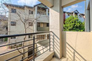 a balcony with stairs in front of a building at Grace Haven in Sandton