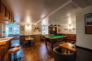 a pub with a pool table in a room at Redesdale Arms in Otterburn