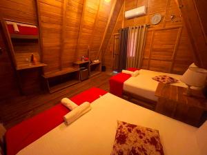 a room with two beds in a wooden room at Ama Villa - Habarana in Habarana