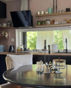 a dining room table with a glass table top at Cabana207 - Private Mountain Cabin with Hot Tub in Bulz