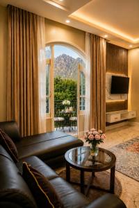 a living room with a couch and a table at Vale Montis Near Dal Lake Srinagar in Srinagar