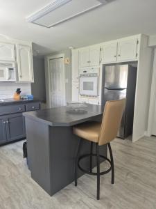 a kitchen with a black counter and a refrigerator at Comfortable stay - 2-bedroom apartment in Saint John +21 photos