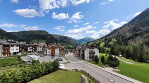 a view of a town in the mountains at Apartments Alpenroyal Arabba - Check-in at Garni Royal in Arabba +44 photos
