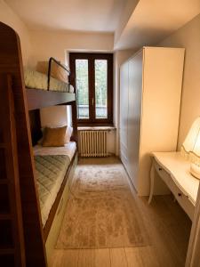 a room with two bunk beds and a desk at Siham lake home in Verceia