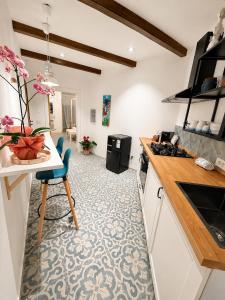 a kitchen with a table and a chair in a room at Le Tartarughe - Rooms and Apartments - in Milazzo