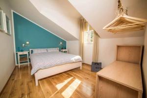 a bedroom with a bed and a blue wall at Apartments Marijin Dvor in Splitska