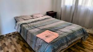 a bed with a quilt on it in a bedroom at Las Lomas Hotel in Caraz +49 photos