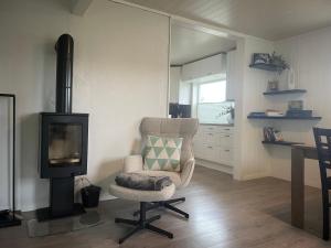 a living room with a chair and a television at Sivi`s hus in Moskenes +35 photos