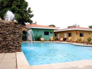a swimming pool with a water fountain at Hotel Los Chilamates in Granada