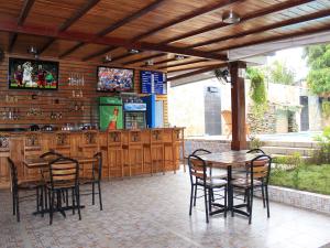 a patio with a bar with chairs and a table at Hotel Los Chilamates in Granada