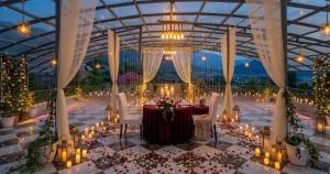 a banquet hall with a table with candles and lights at Vale Montis Near Dal Lake Srinagar in Srinagar