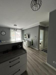 an empty living room with a kitchen and a dining room at Apartament w Dolinie Baryczy in Milicz