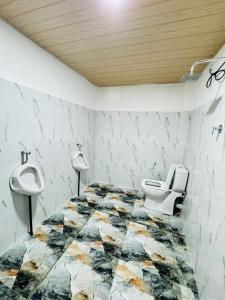 a bathroom with a toilet and a sink at Glowhaven Hostel in Sigiriya