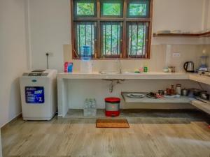 a kitchen with a sink and a refrigerator at White Villa Goyambokka - Private Pool Villa in Tangalle +142 photos