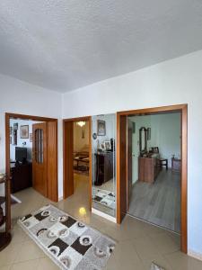 a living room with a large glass door to a room at The Grandparent's House in Piskupat