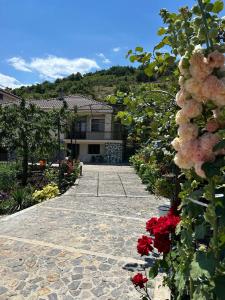 a walkway with flowers in front of a house at The Grandparent's House in Piskupat