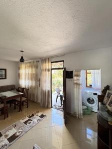 a living room with a table and a dining room at The Grandparent's House in Piskupat