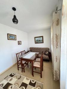 a living room with a table and chairs and a couch at The Grandparent's House in Piskupat +10 photos