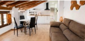 a living room with a couch and a table and chairs at Origen&Madera in Alcalá del Júcar