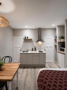 a kitchen with a sink and a table in it at LE 139 carcassonne in Carcassonne