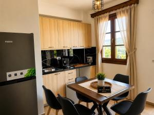 a kitchen with a table and chairs in a kitchen at Villa Monte Shpirag in Berat